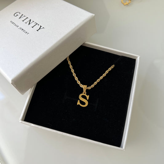 Gold initial necklace.