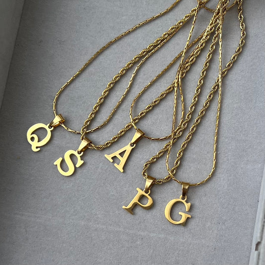 Gold initial necklace.
